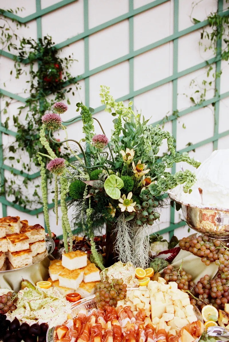 Artistic grazing table display with stunning florals, focaccia, and artisanal cheeses